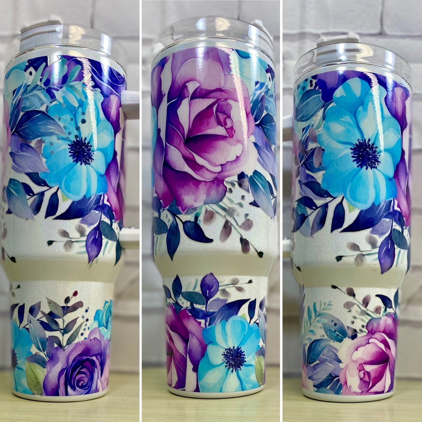 A 40oz stainless steel tumbler with a floral design featuring purple and blue flowers and green leaves, without epoxy.