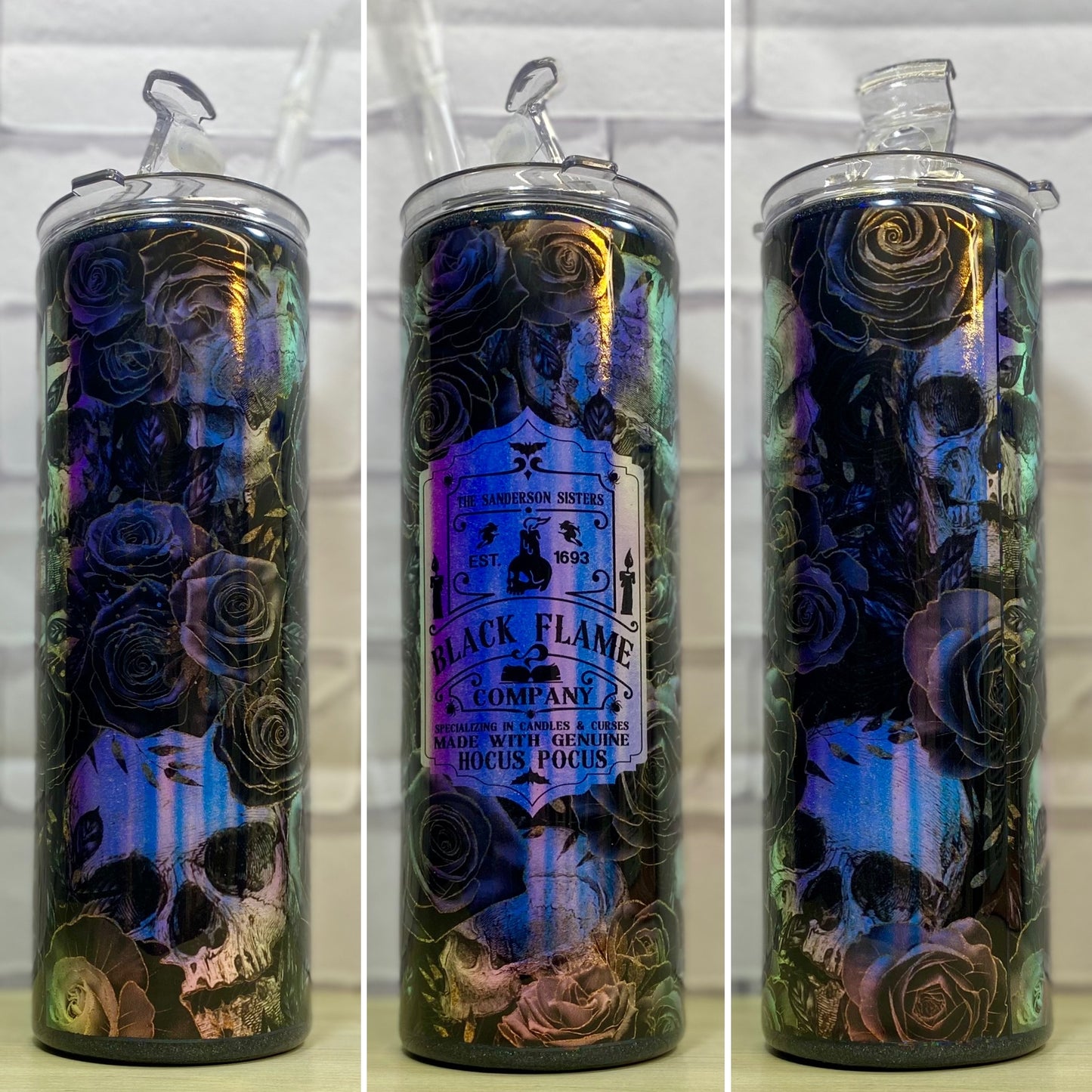A stainless steel tumbler with a black and blue flame design and a skull motif