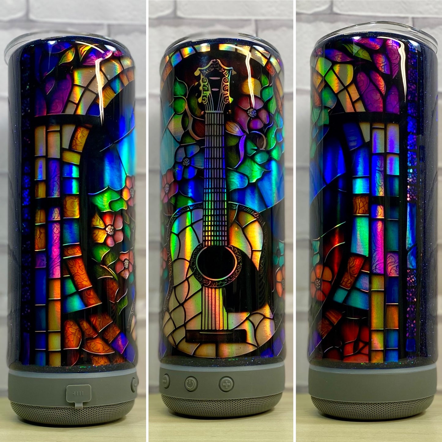 A Bluetooth speaker stainless steel tumbler with a colorful holographic mosaic pattern shaped like a guitar on it.