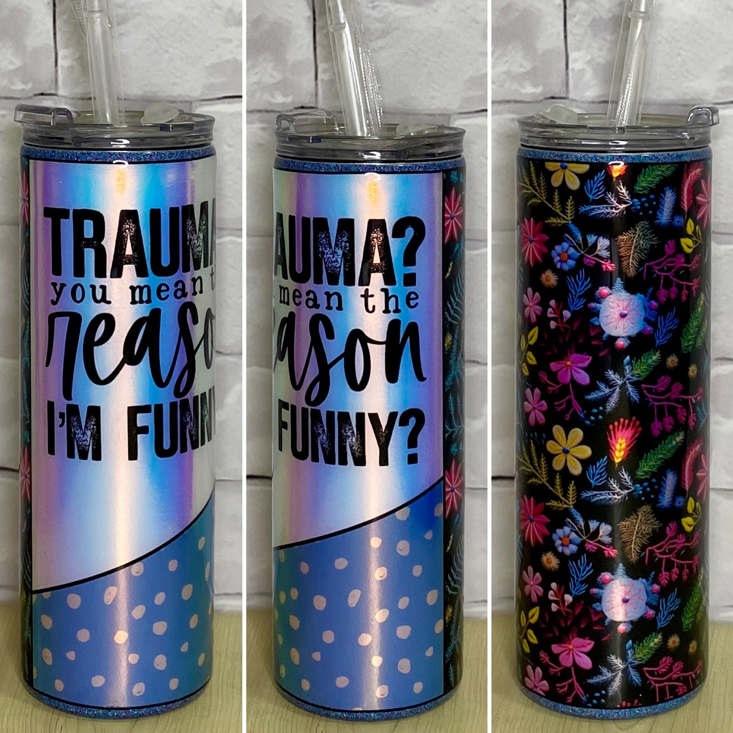 A floral glittered tumbler with a holographic design that reads trauma? you mean the reason I'm funny?