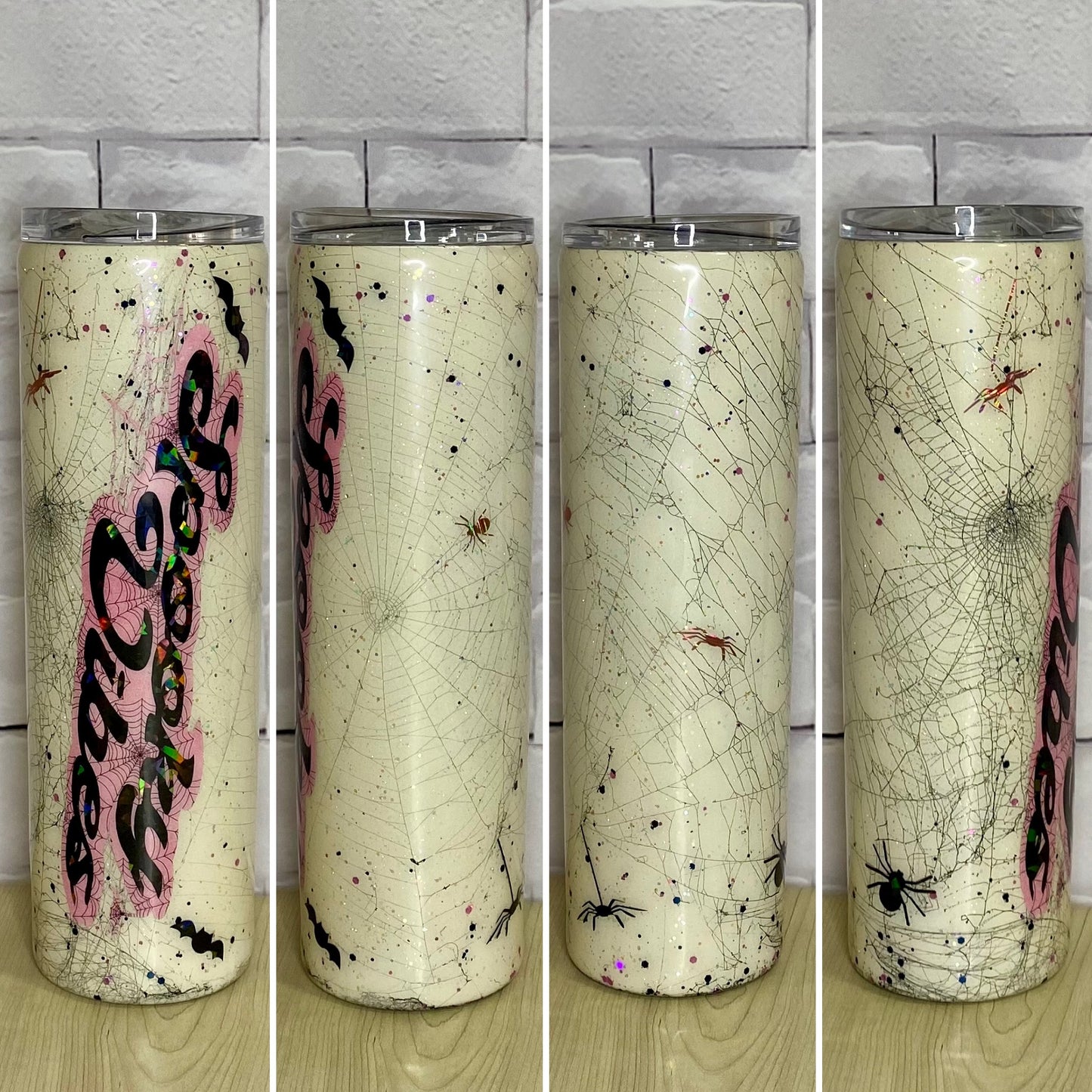 A white glittered tumbler with spider webs and the words "Spooky Vibes"