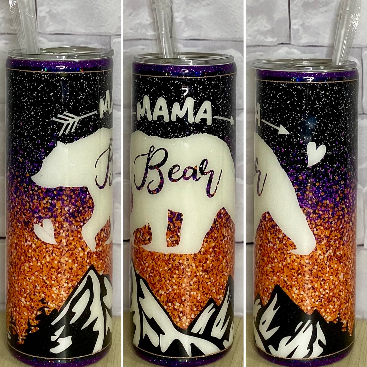 A stainless steel tumblers with black, purple and gold glitter with a bear and mountains that says mama bear.