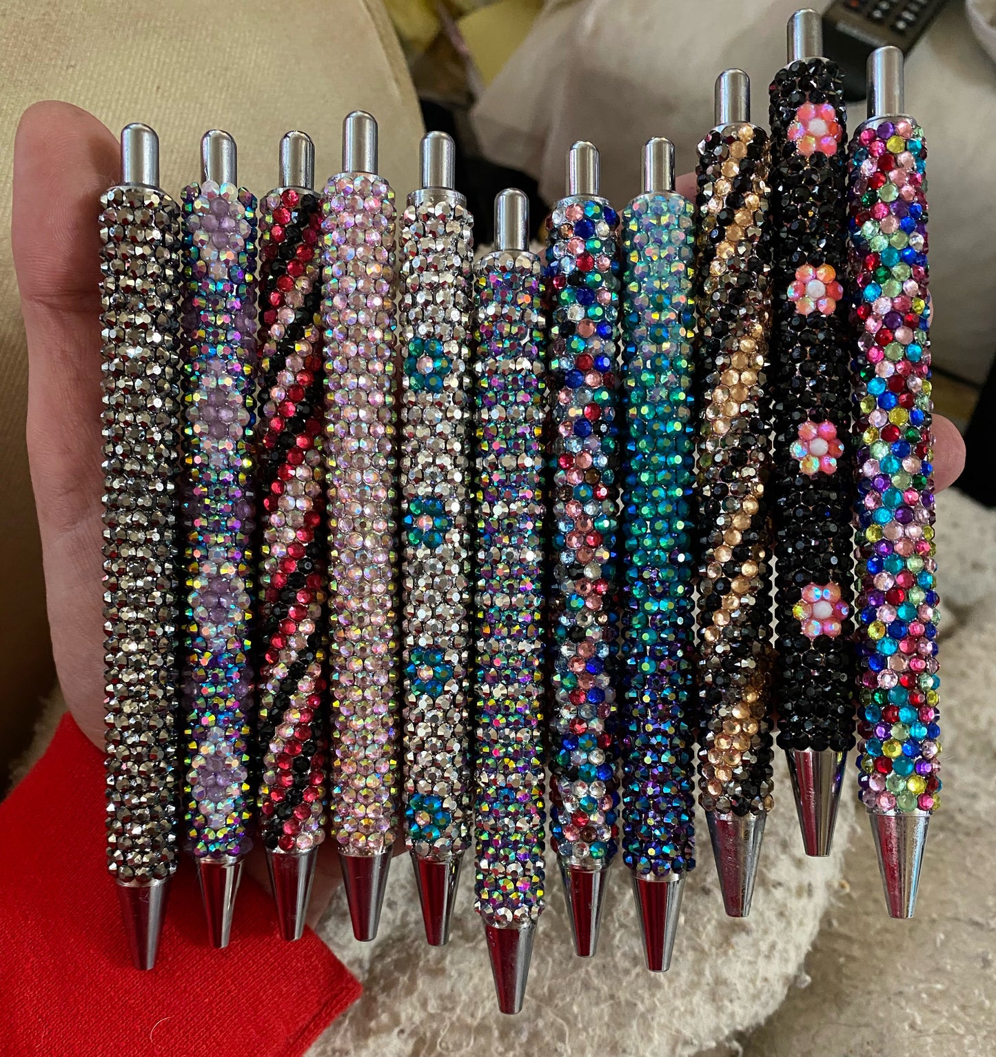 A assortment of rhinestoned pens in various colours and patterns