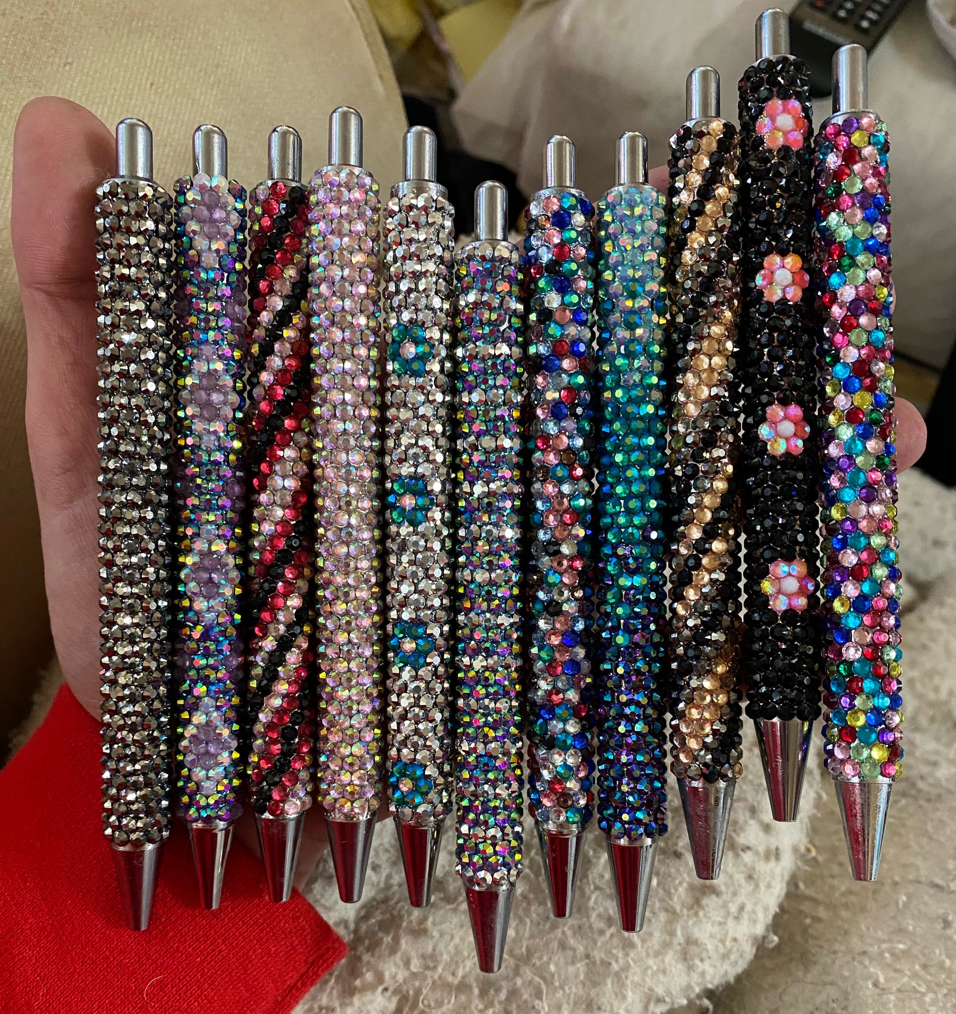 A assortment of rhinestoned pens in various colours and patterns